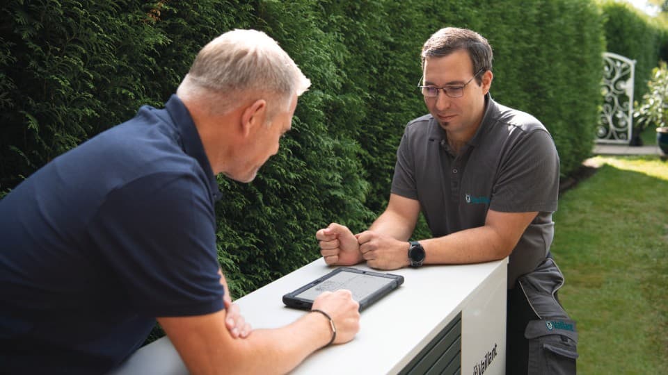 Installer and Vaillant service technician installing a heat pump.